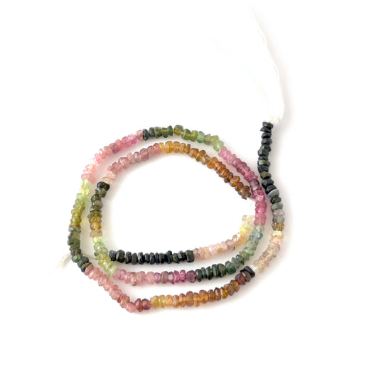 Faceted rondelle Watermelon Tourmaline beads arranged neatly, highlighting their polished finish and handmade jewellery component quality.