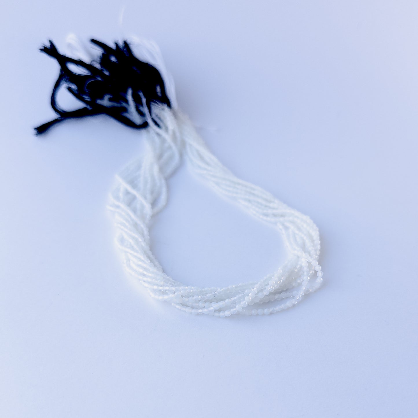 Natural White Chalcedony faceted rondelle stone beads 2.1mm displayed neatly for DIY jewellery and authentic gemstone designs.
