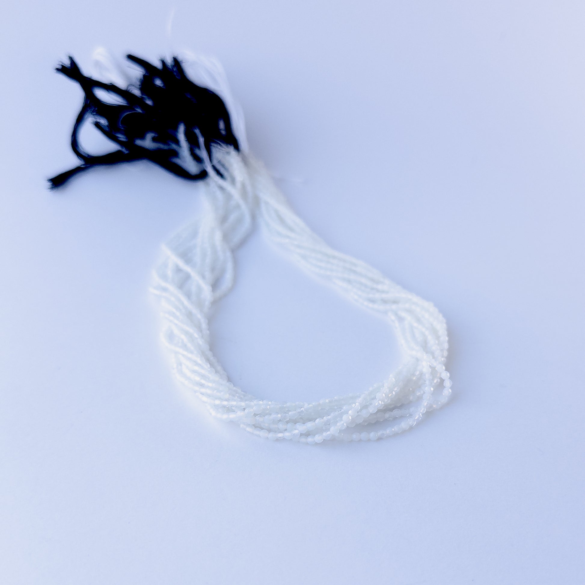 Natural White Chalcedony faceted rondelle stone beads 2.1mm displayed neatly for DIY jewellery and authentic gemstone designs.