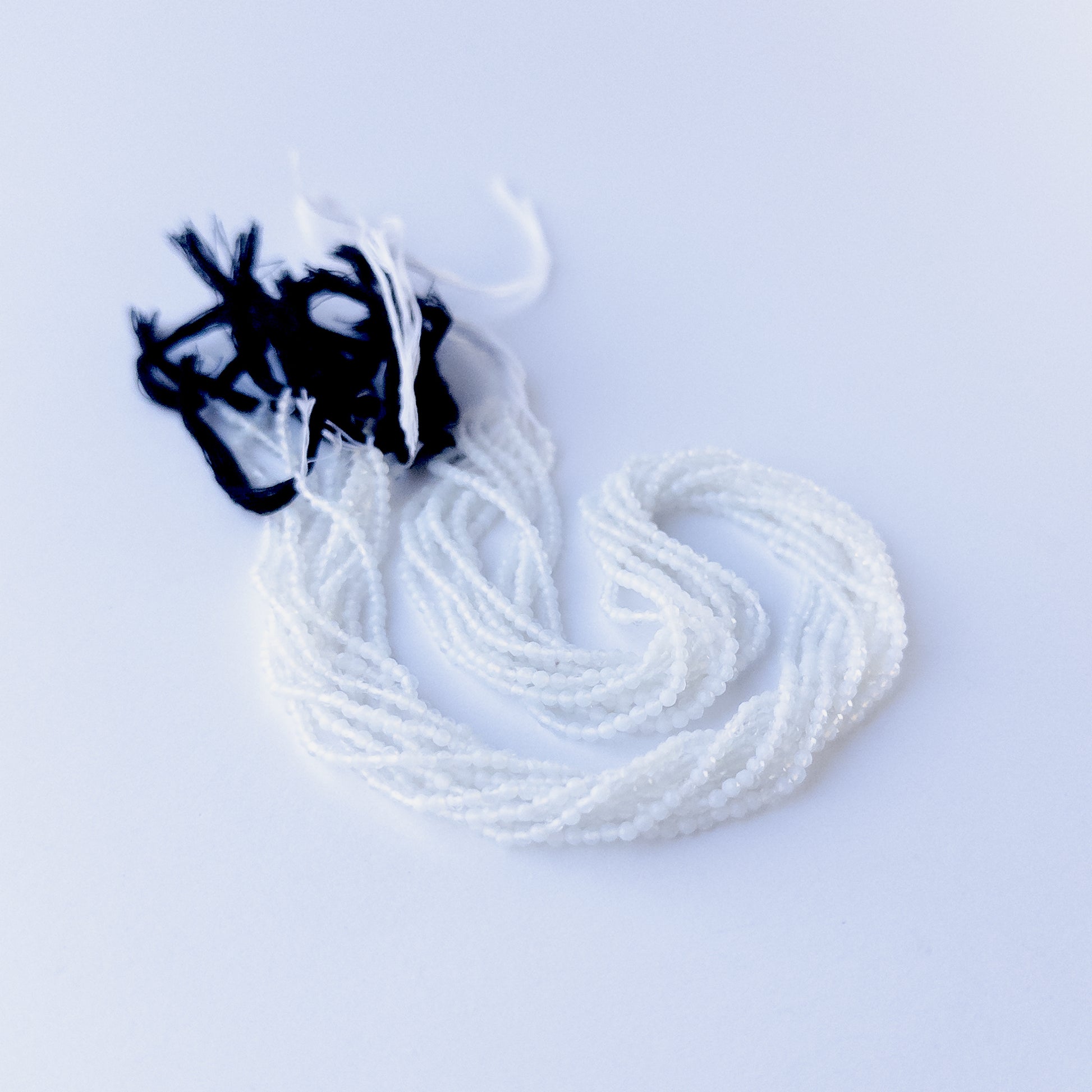 Handmade jewellery components featuring authentic White Chalcedony faceted rondelle beads with soft white sparkle.
