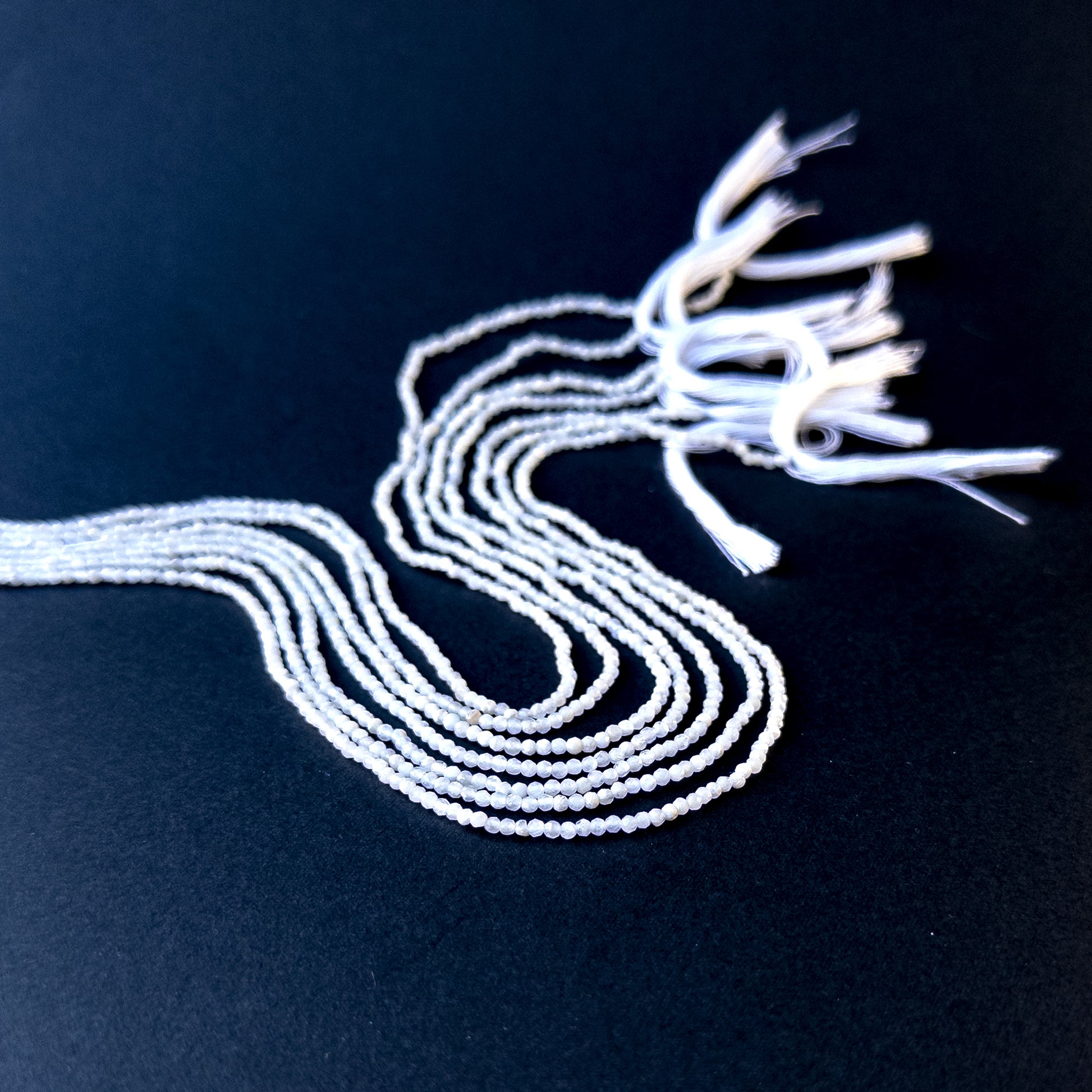 Authentic white opal gemstone beads with polished faceted rondelle cuts, ideal for handmade jewellery components.