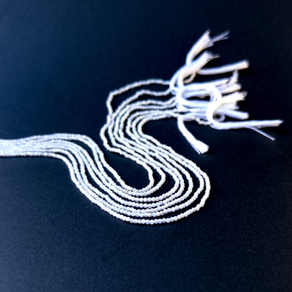 Authentic white opal gemstone beads with polished faceted rondelle cuts, ideal for handmade jewellery components.