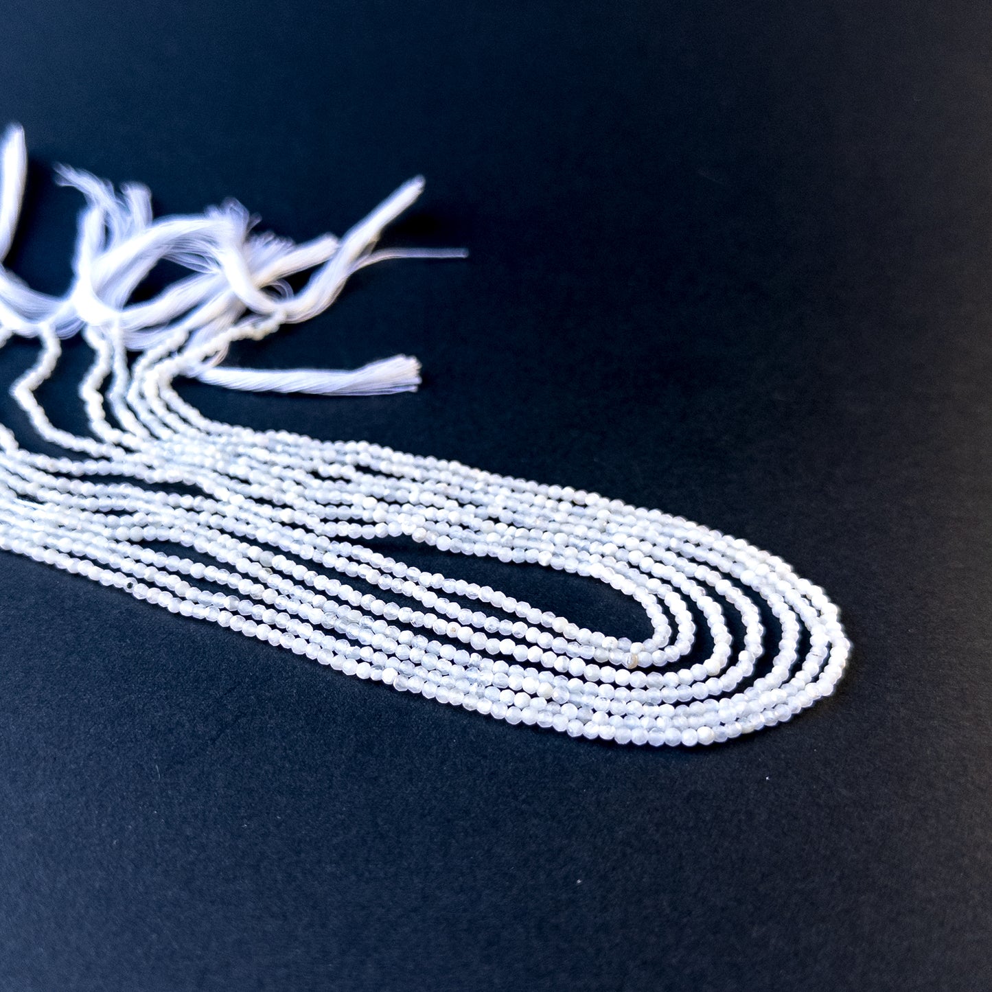 Genuine stone beads with soft white tones and subtle fire, featuring faceted rondelles for DIY jewellery making.