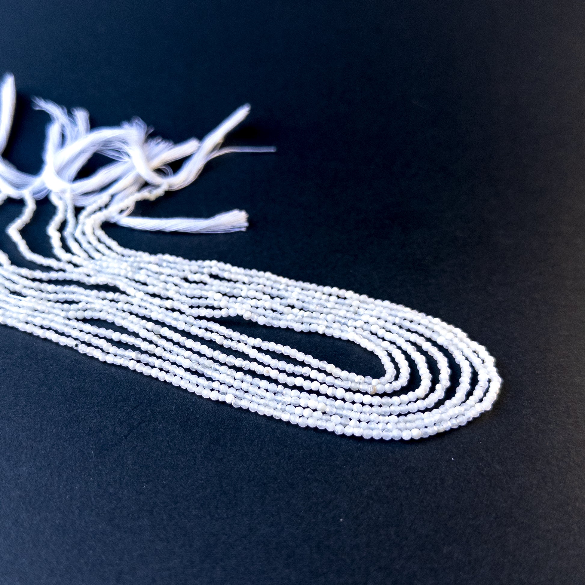 Genuine stone beads with soft white tones and subtle fire, featuring faceted rondelles for DIY jewellery making.