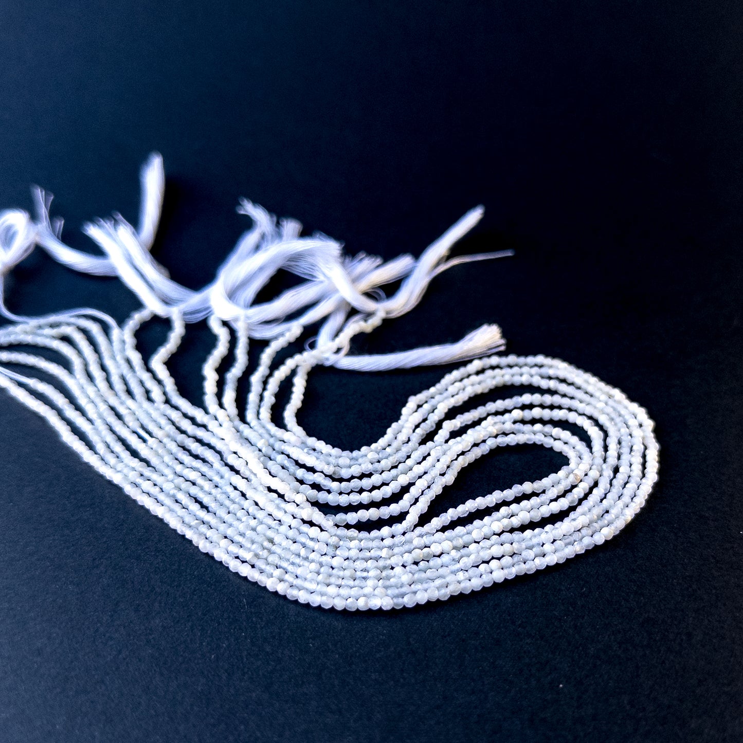 High‑quality white opal rondelle gemstone beads with bright shine and natural colour play on a long strand.