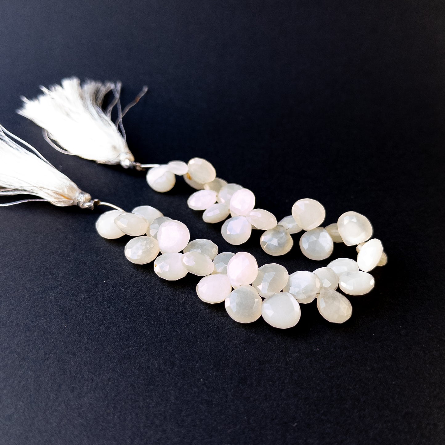 Genuine stone beads with soft white tones and rainbow flashes, featuring faceted briolettes for DIY jewellery making.
