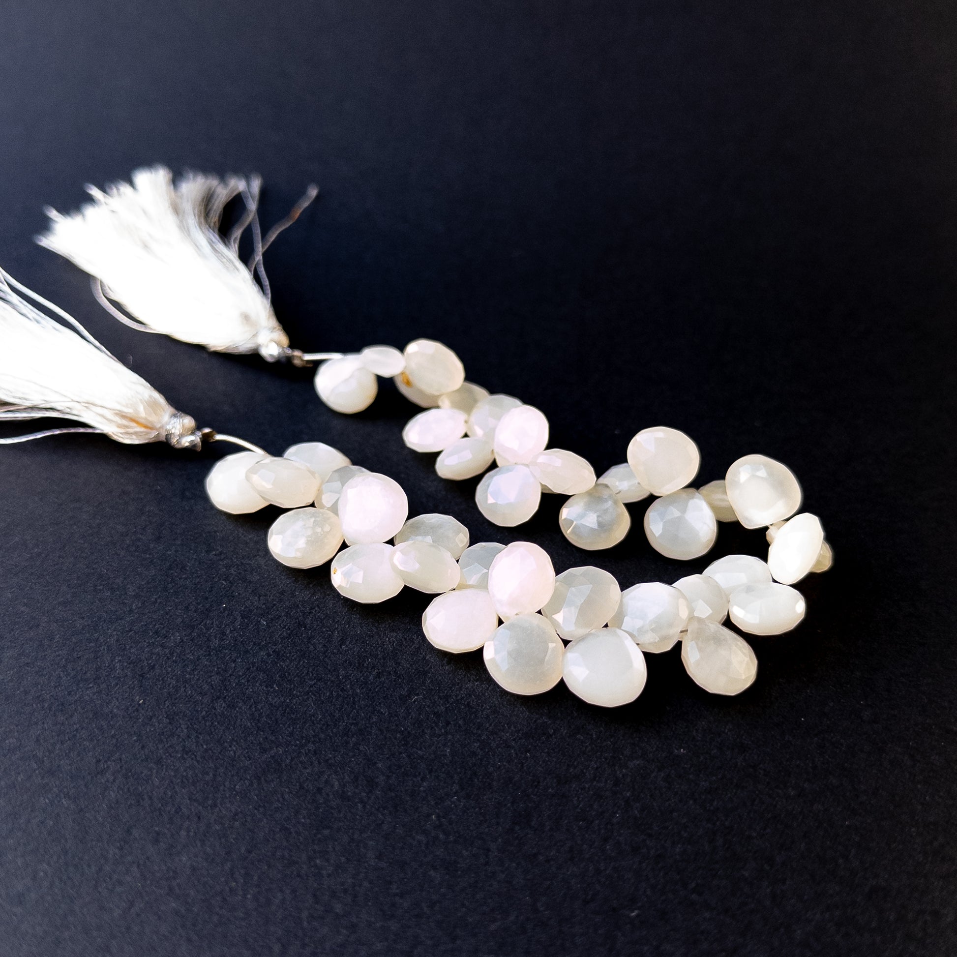 Genuine stone beads with soft white tones and rainbow flashes, featuring faceted briolettes for DIY jewellery making.