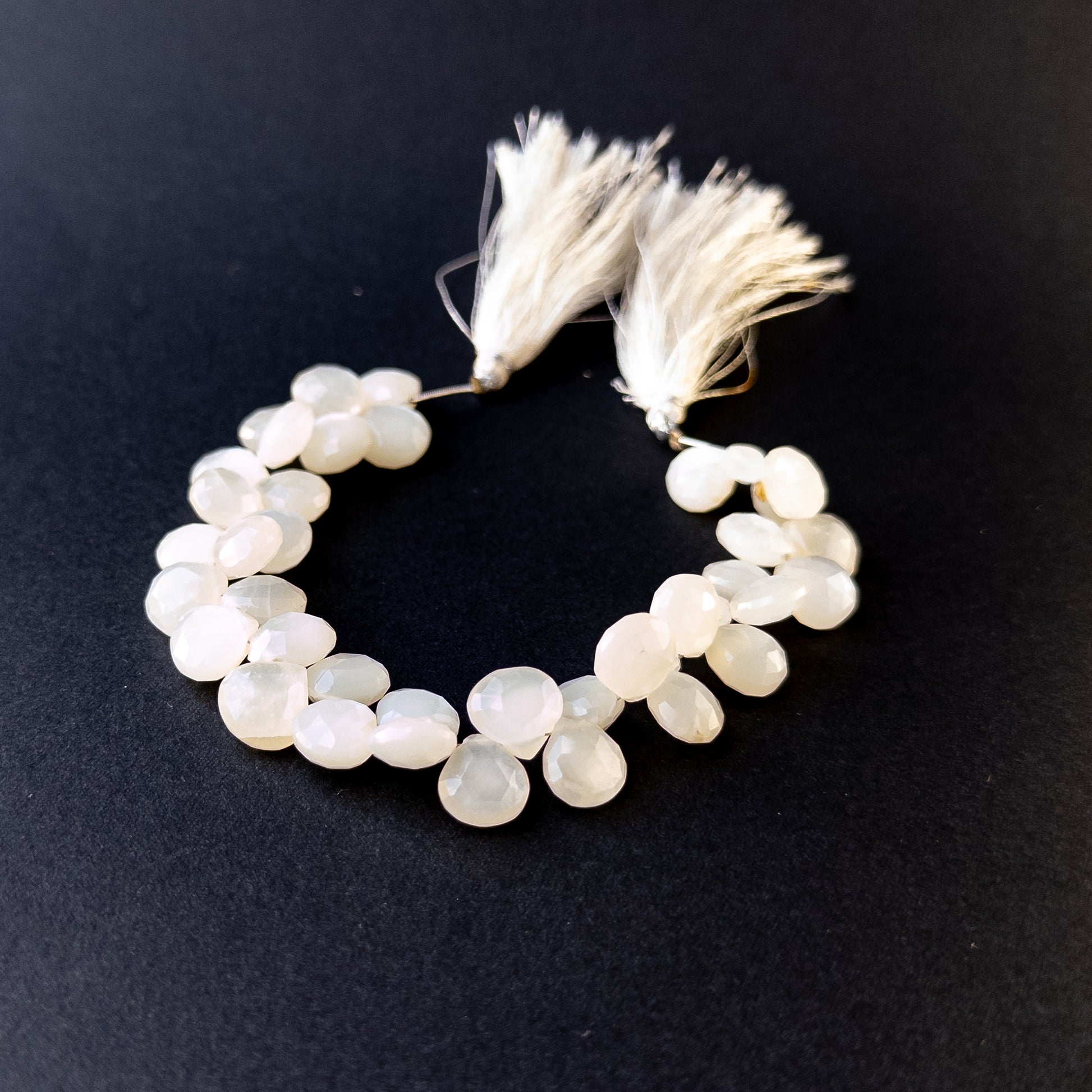 Authentic white rainbow moonstone beads with polished faceted briolette cuts, ideal for handmade jewellery components.
