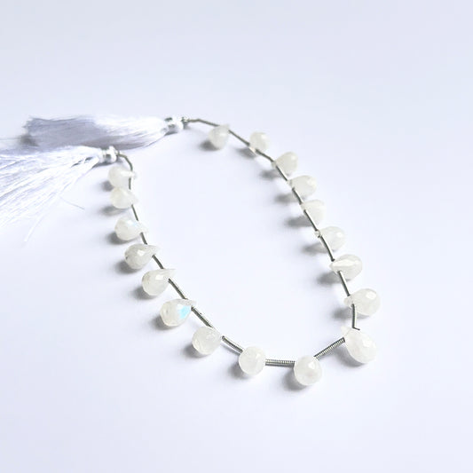 White rainbow moonstone faceted briolettes showing natural shimmer and fine cut for handmade jewellery.