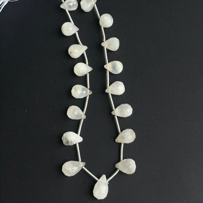 Faceted rainbow moonstone beads displayed with bright reflective surfaces ideal for jewellery making.