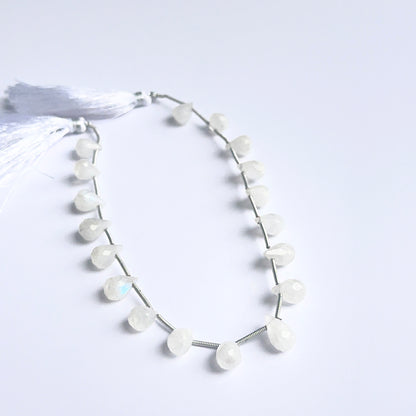 Moonstone faceted briolettes arranged neatly to showcase natural gemstone quality and soft rainbow flash.