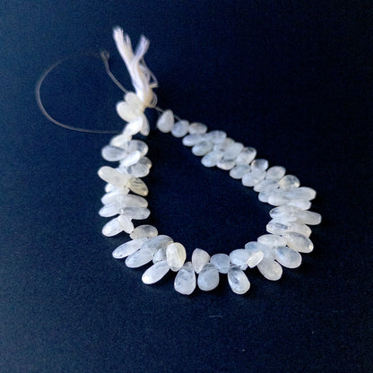 White Rainbow Moonstone faceted briolette pear beads arranged on a 27cm strand with natural glow for handmade jewellery components.