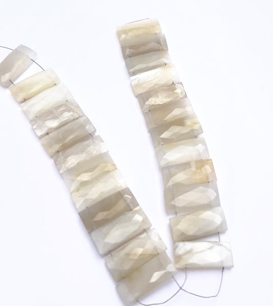 White Rainbow Moonstone beads for DIY jewellery displayed with soft lighting and texture.