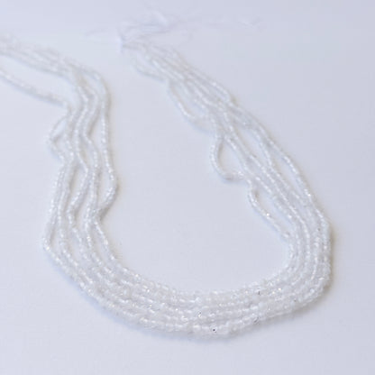 Delicate Rainbow Moonstone micro‑faceted beads showcasing shimmer and clarity for DIY gemstone designs.