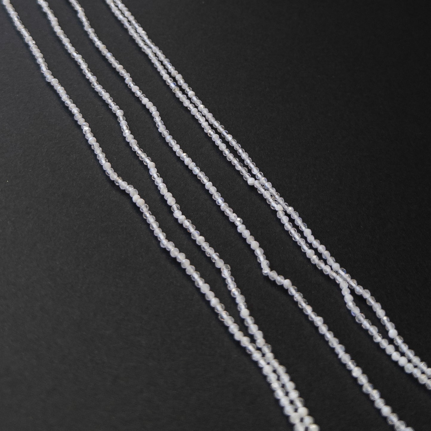 High‑quality White Moonstone faceted rondelles arranged neatly for gemstone jewellery making.