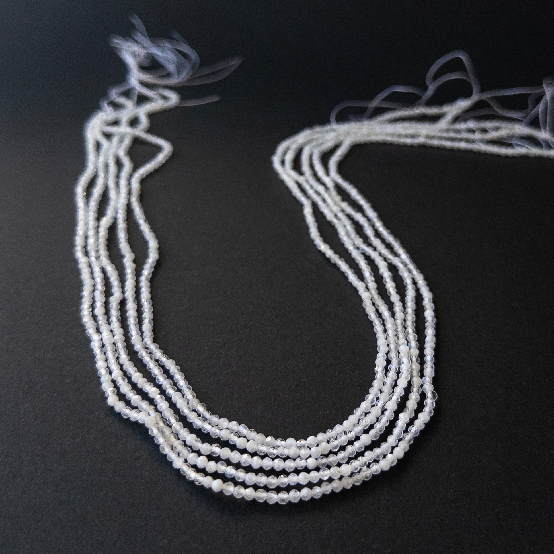 Authentic Rainbow Moonstone rondelle beads showing subtle blue flash and sparkle for artisan beadwork.