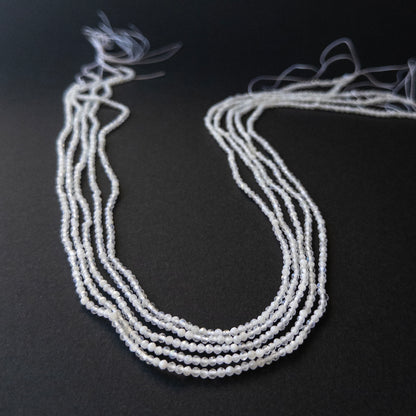 Authentic Rainbow Moonstone rondelle beads showing subtle blue flash and sparkle for artisan beadwork.