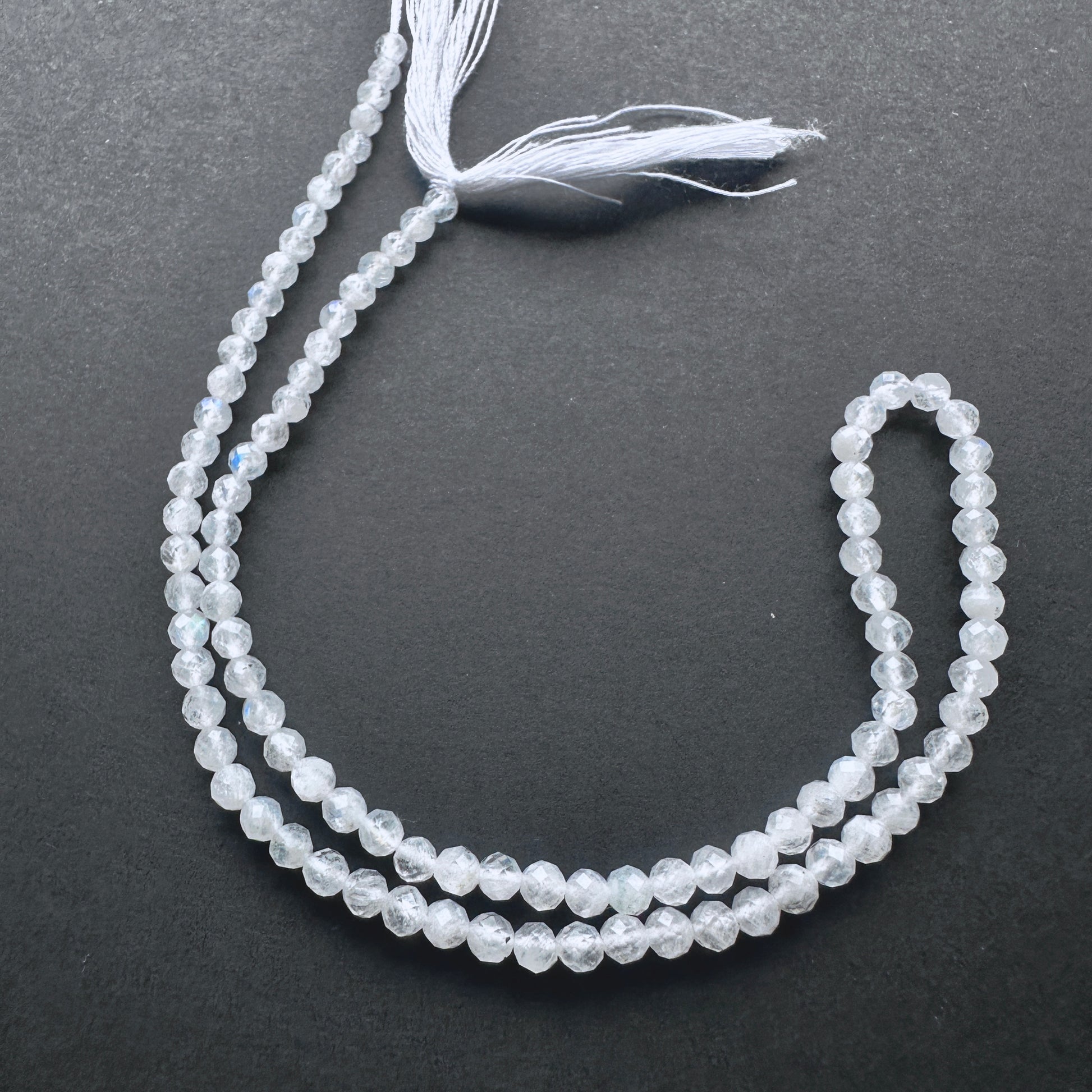 White Rainbow Moonstone faceted rondelle beads with blue flashes and polished sparkle for handmade jewellery components.