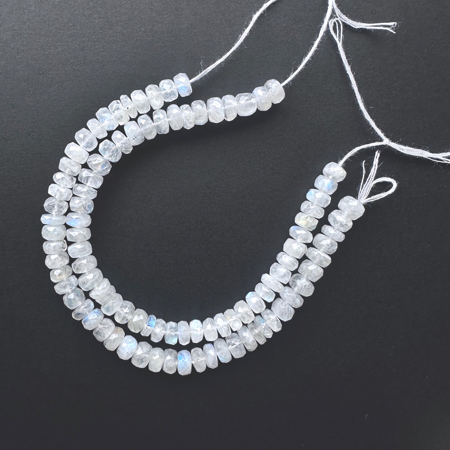 Natural gemstone beads featuring White Rainbow Moonstone with polished facets and consistent cut.