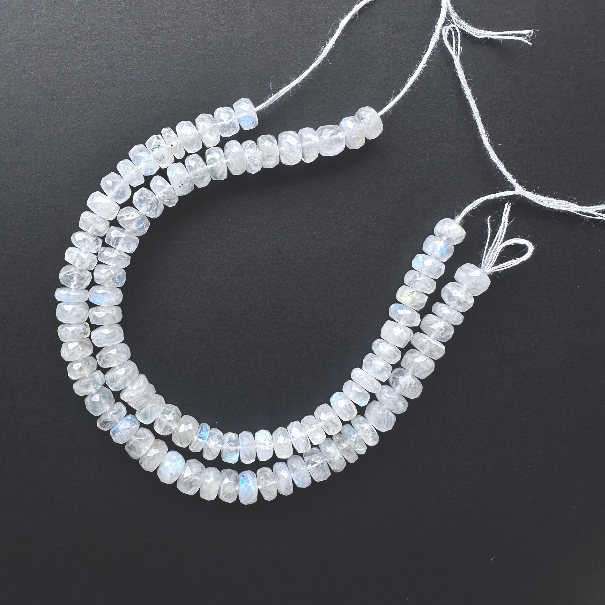 Natural gemstone beads featuring White Rainbow Moonstone with polished facets and consistent cut.