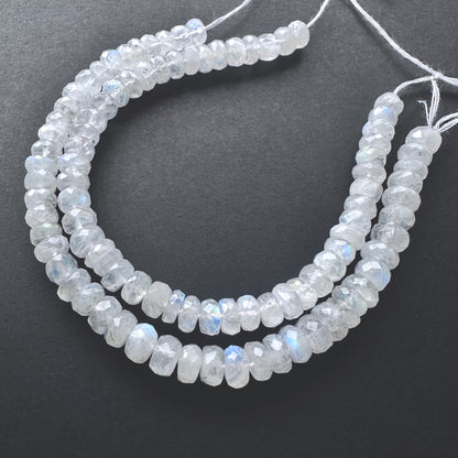 Close-up of White Rainbow Moonstone beads showcasing their iridescent glow and precision faceting.