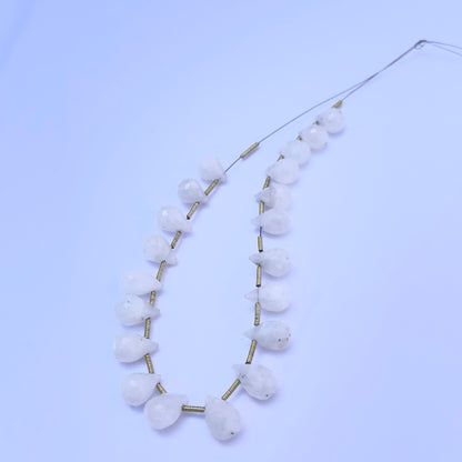 Faceted teardrop Moonstone beads displayed with soft lighting to highlight their cut and polish.