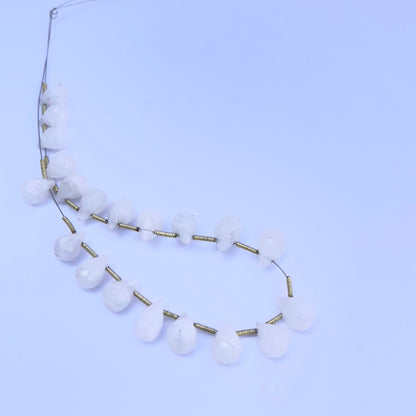 Close-up of shimmering White Rainbow Moonstone beads showing their natural colour play and clarity.