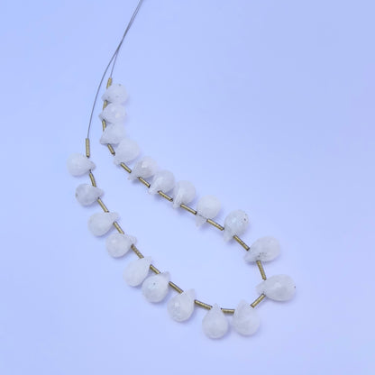 White Rainbow Moonstone gemstone beads laid out for DIY jewellery making and design inspiration.