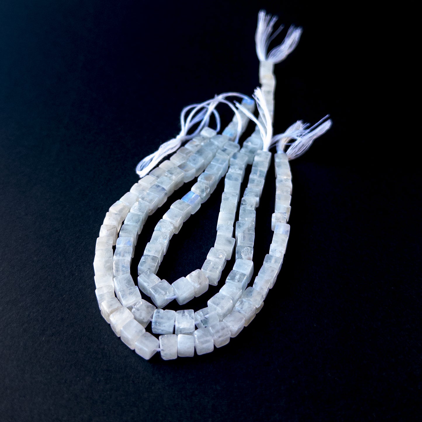 Handmade jewellery components featuring White Rainbow Moonstone cube gemstone beads in assorted sizes.