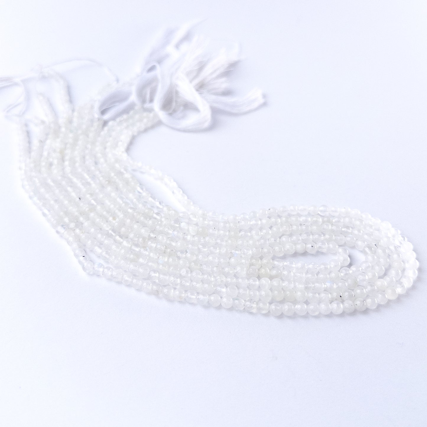 Genuine White Rainbow Moonstone stone beads for DIY jewellery featuring polished round shaping and luminous colour.