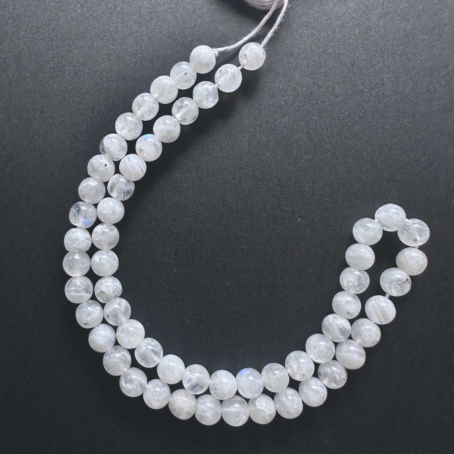 White Rainbow Moonstone smooth round beads with iridescent blue flashes and polished finish for handmade jewellery components.