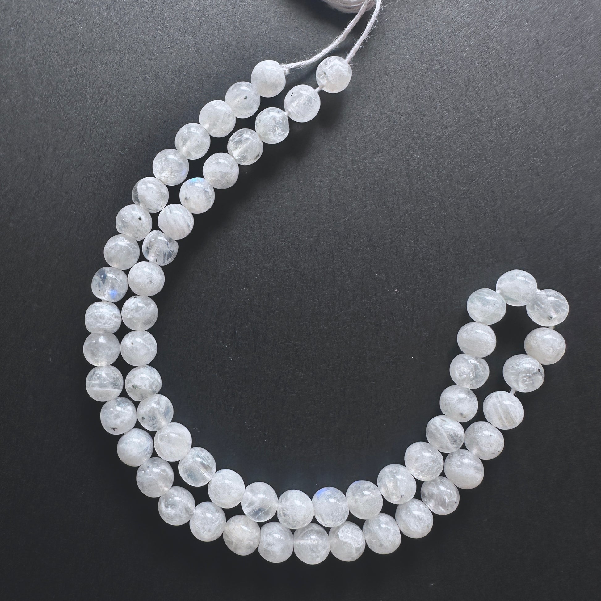 White Rainbow Moonstone smooth round beads with iridescent blue flashes and polished finish for handmade jewellery components.