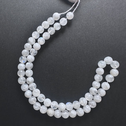 White Rainbow Moonstone smooth round beads with iridescent blue flashes and polished finish for handmade jewellery components.