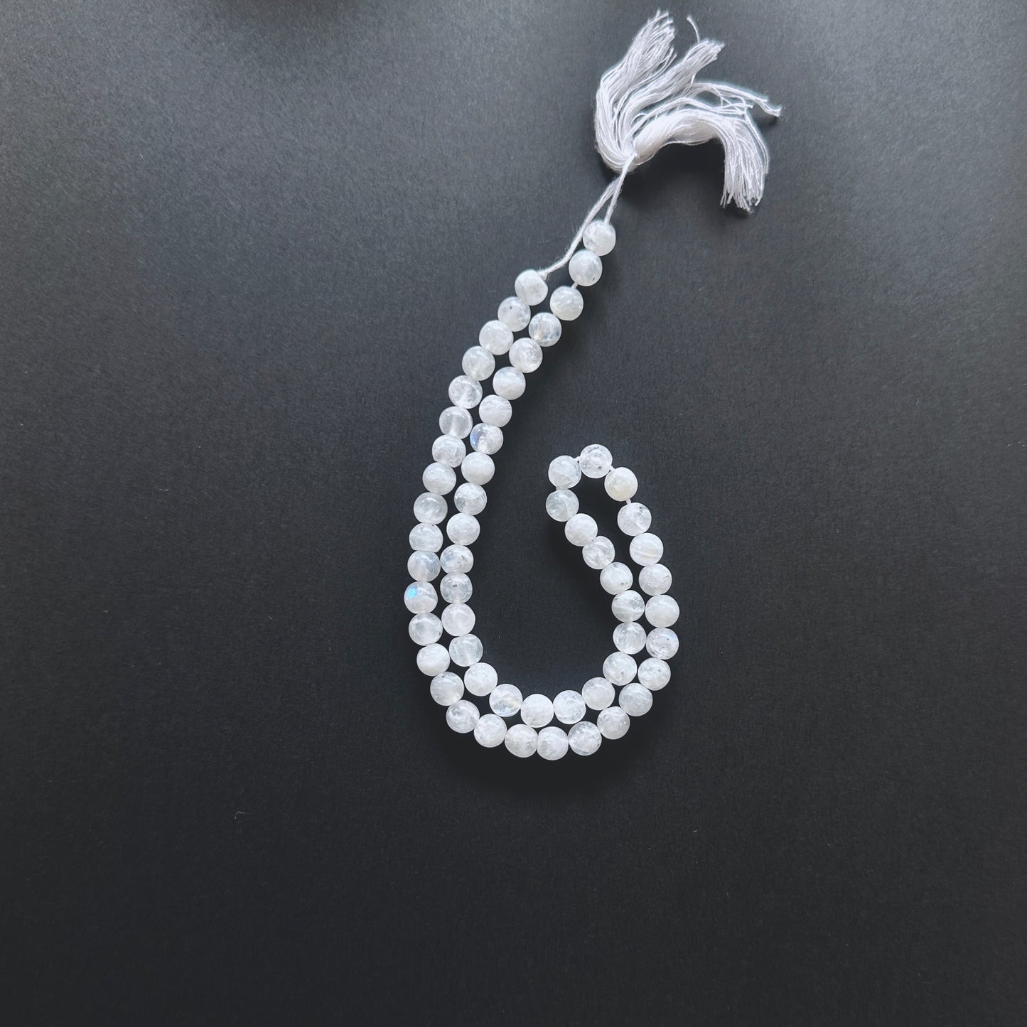 Natural gemstone beads in White Rainbow Moonstone with 6-6.5mm size and 0.5mm drilled holes.