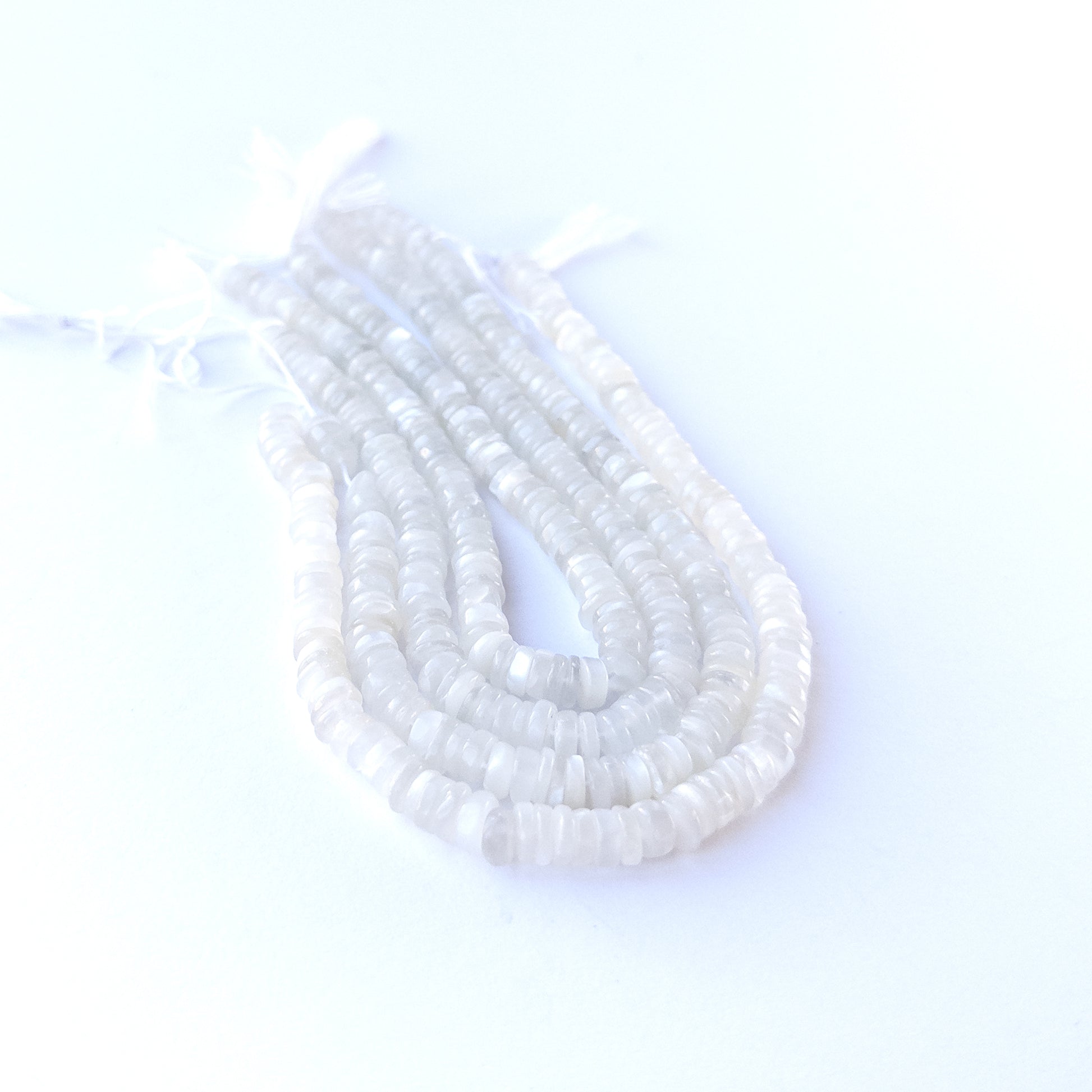 Premium Moonstone smooth wheel beads arranged neatly on a short strand with refined disc‑like shaping.
