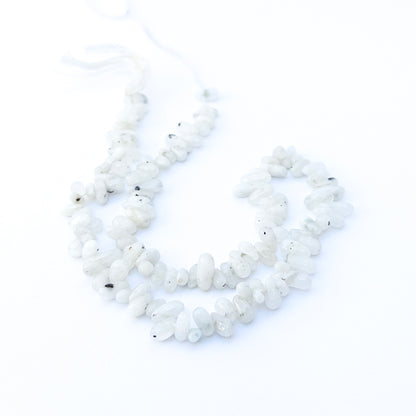 Genuine White Rainbow smooth nugget beads with soft glow, ideal for handmade jewellery components and elegant designs.