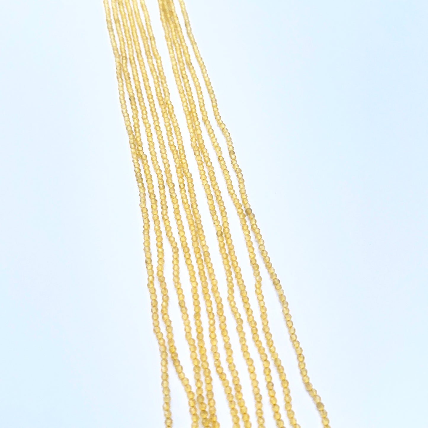 Natural chalcedony strnad featuring tiny faceted rondelles with vibrant colour.