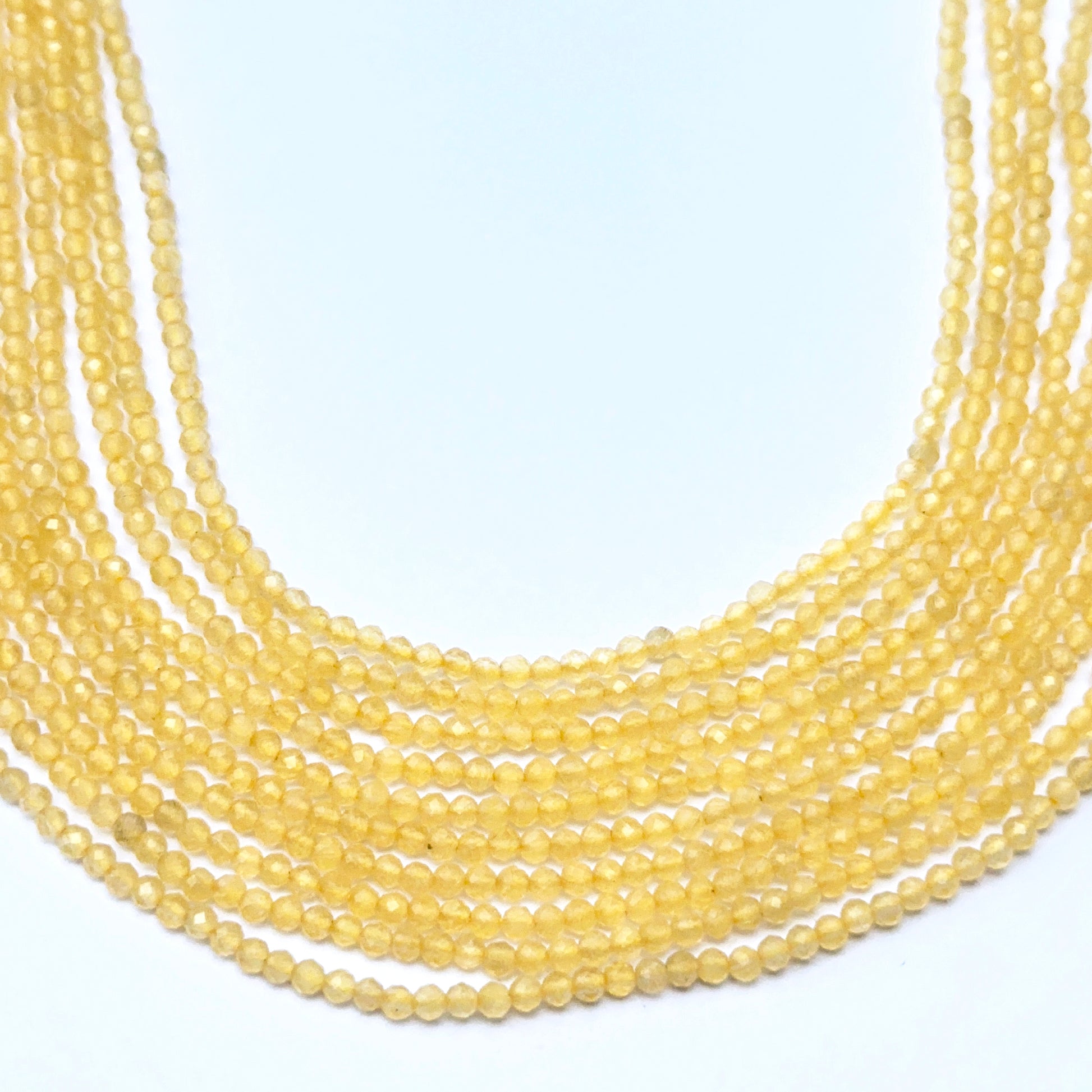 Yellow chalcedony strand with faceted rondelle beads showing bright lemon‑yellow sparkle.