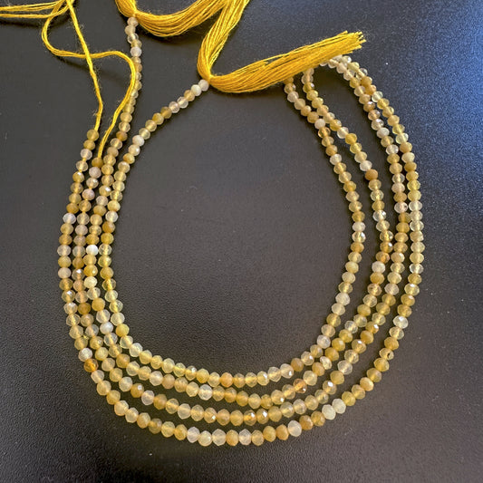 Yellow opal micro faceted rondelle beads in 2.2mm size sparkle softly across a 32cm strand.