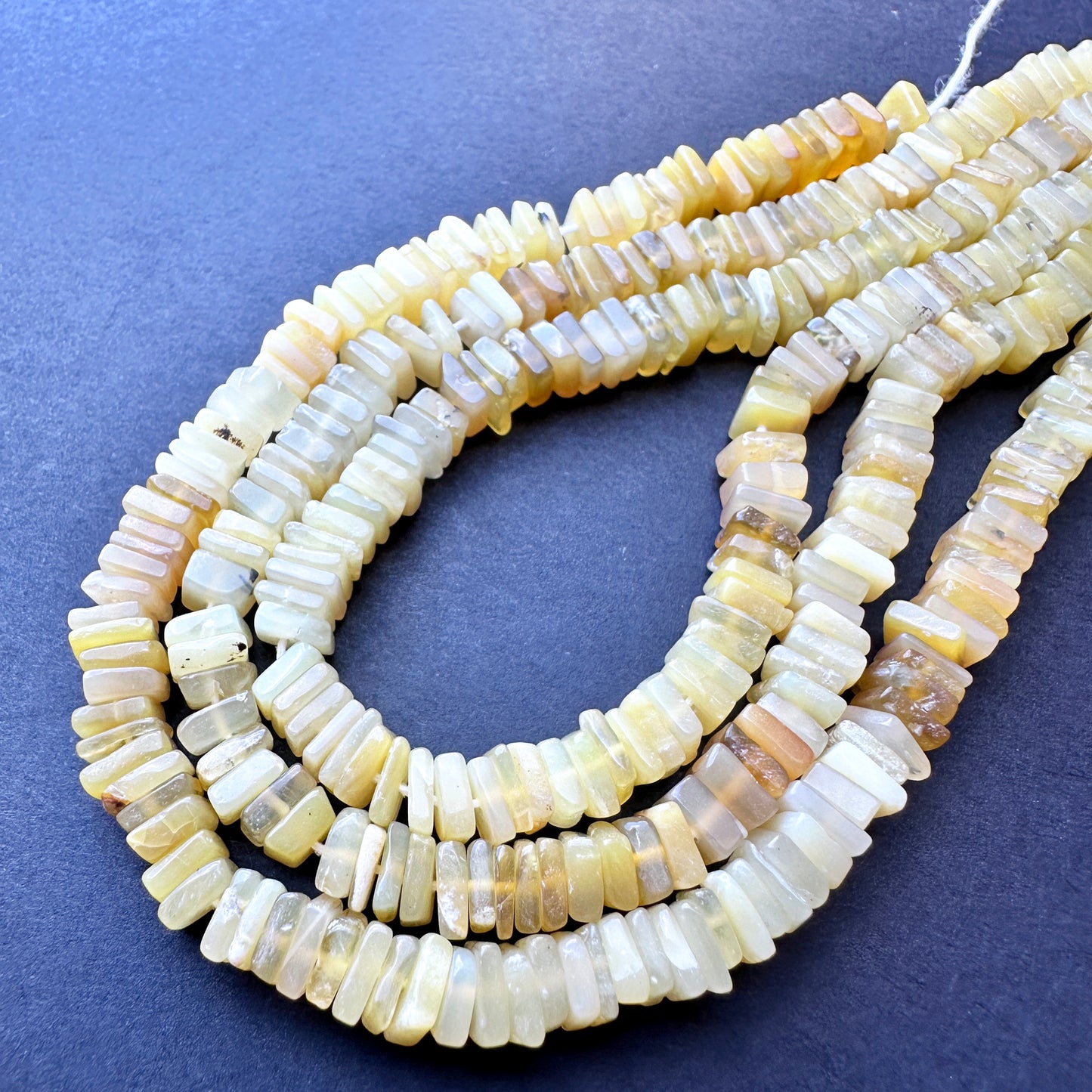 Yellow opal beads with soft lustre and smooth edges, ideal for crafting stylish handmade jewellery accessories.