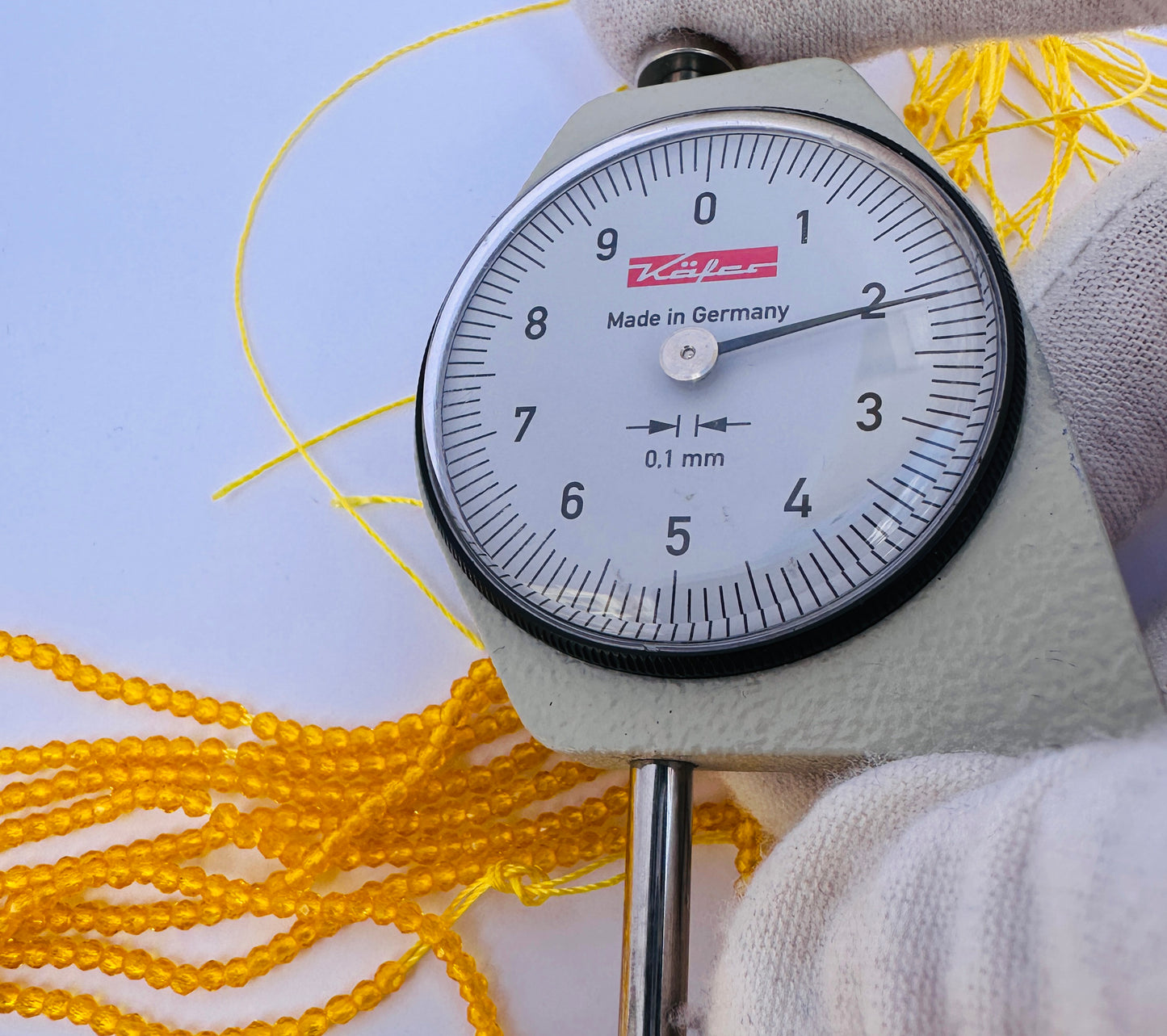 A dial gauge measures the Yellow Quartz faceted rondelle 2.2mm gemstone.