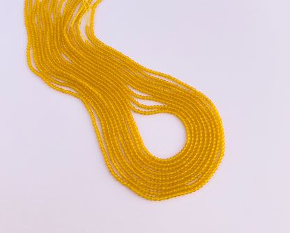 Close-up of Yellow Quartz gemstone beads showing faceted rondelle cut and sparkle.