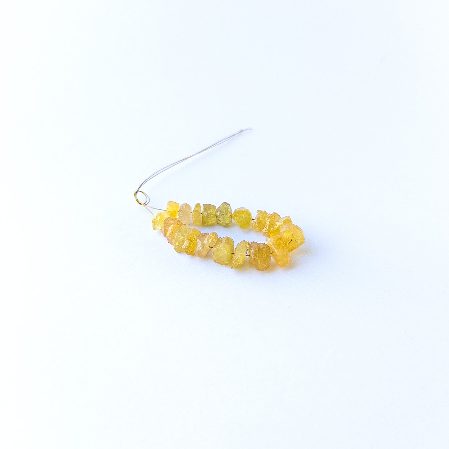Authentic yellow sapphire gemstone beads featuring raw golden colour and organic rough shaping.