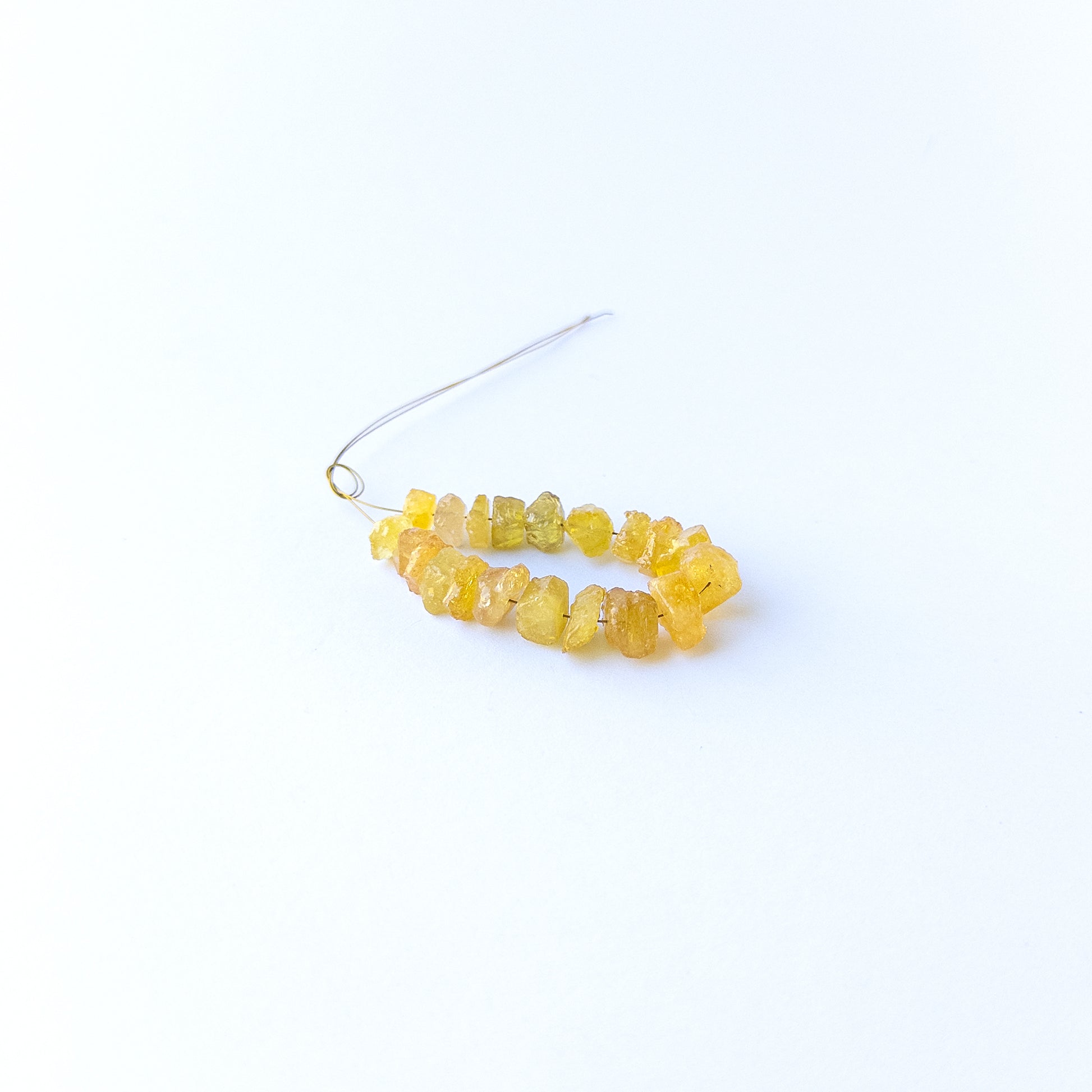 Authentic yellow sapphire gemstone beads featuring raw golden colour and organic rough shaping.