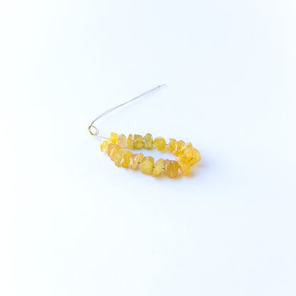 Authentic yellow sapphire gemstone beads featuring raw golden colour and organic rough shaping.