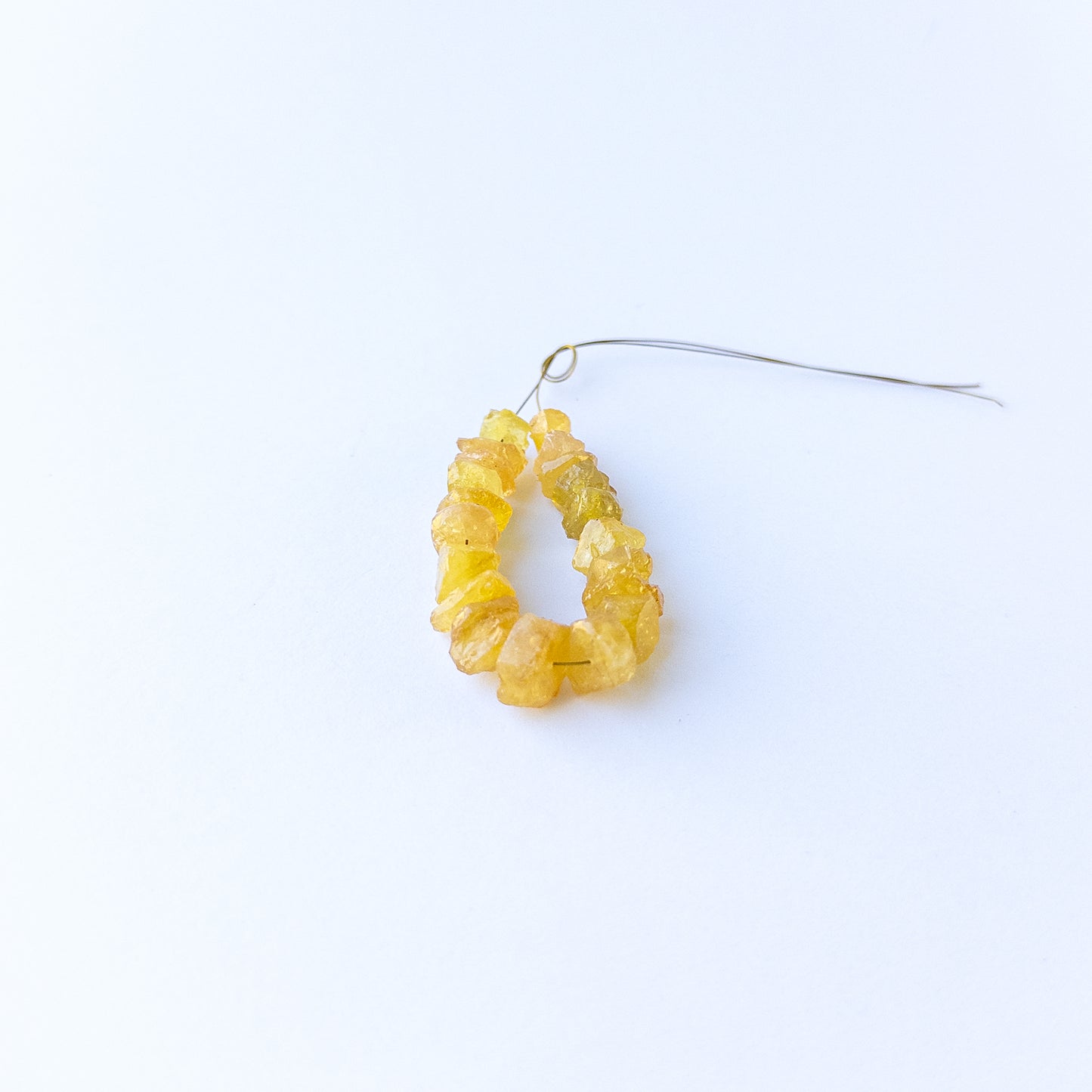 Genuine yellow sapphire stone beads with natural rough texture and drilled finish, ideal for DIY jewellery projects.