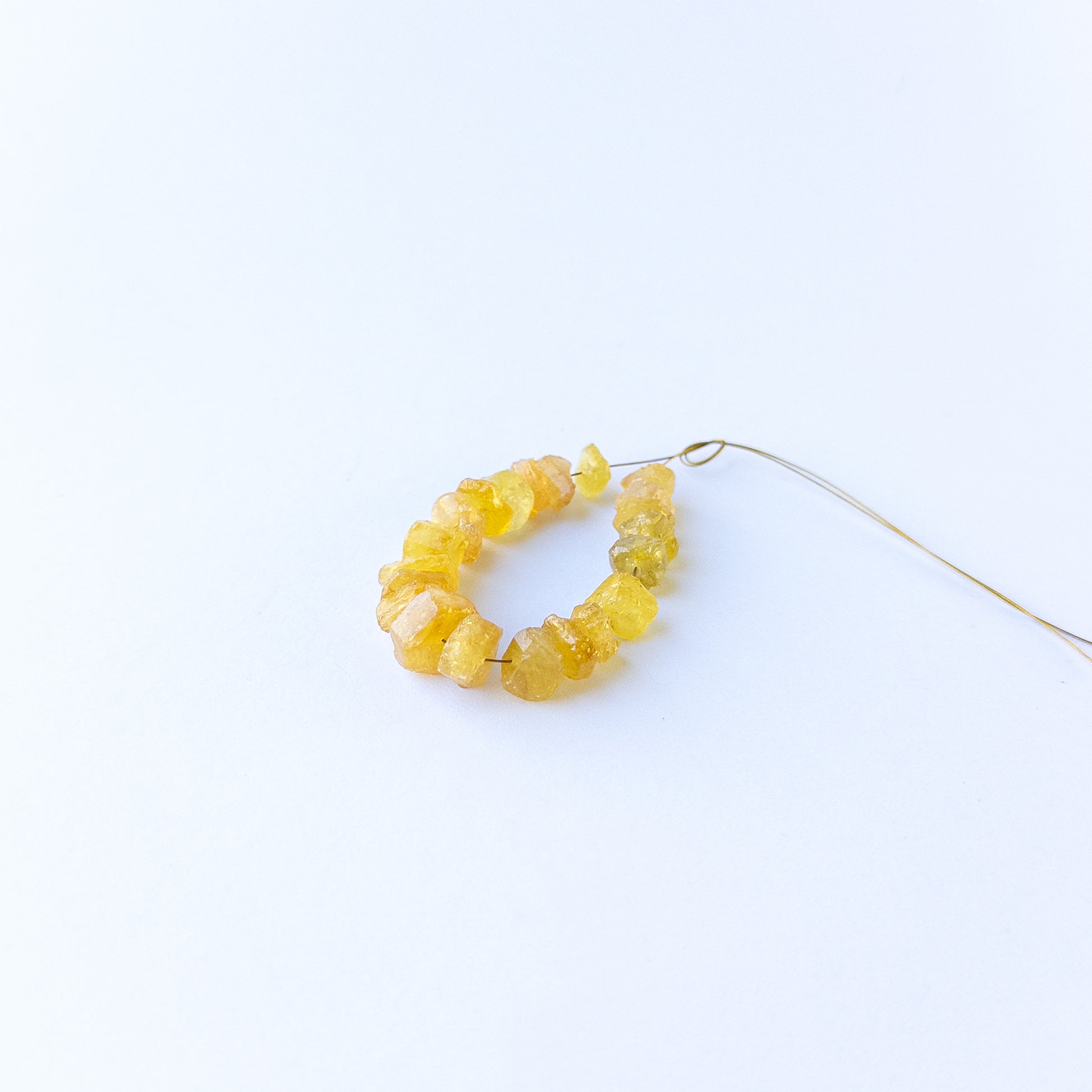 Golden yellow sapphire beads in drilled rough form, perfect for gemstone beads for DIY jewellery and artisan beadwork.