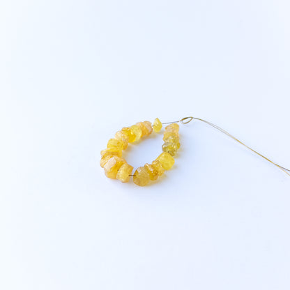Golden yellow sapphire beads in drilled rough form, perfect for gemstone beads for DIY jewellery and artisan beadwork.