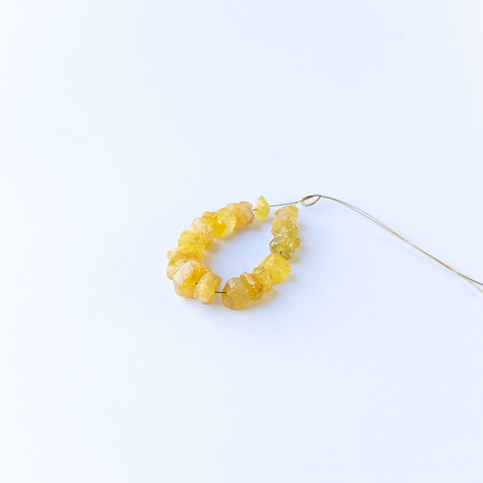 Golden yellow sapphire beads in drilled rough form, perfect for gemstone beads for DIY jewellery and artisan beadwork.